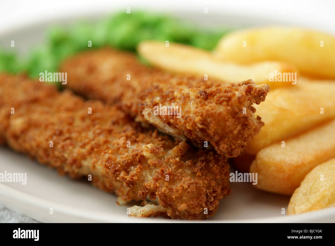 Deep Fried Fish Fingers With Chunky Potato Chips and Peas Served On A