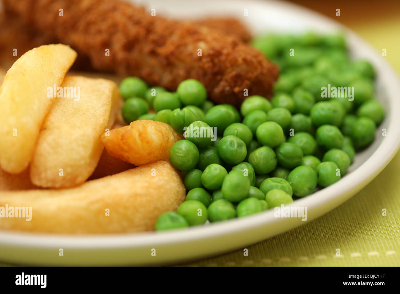 Deep Fried Fish Fingers With Chunky Potato Chips and Peas Served On A