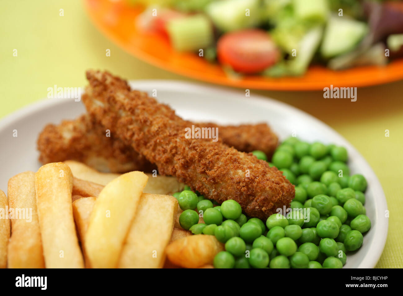 Deep Fried Fish Fingers With Chunky Potato Chips and Peas Served On A