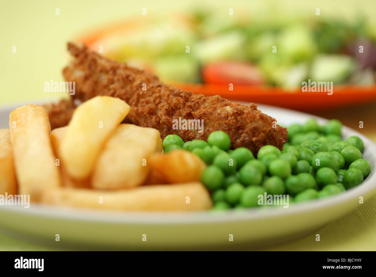 Deep Fried Fish Fingers With Chunky Potato Chips and Peas Served On A