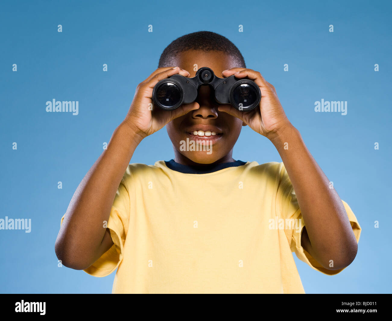 Child looking through binoculars Stock Photo Alamy