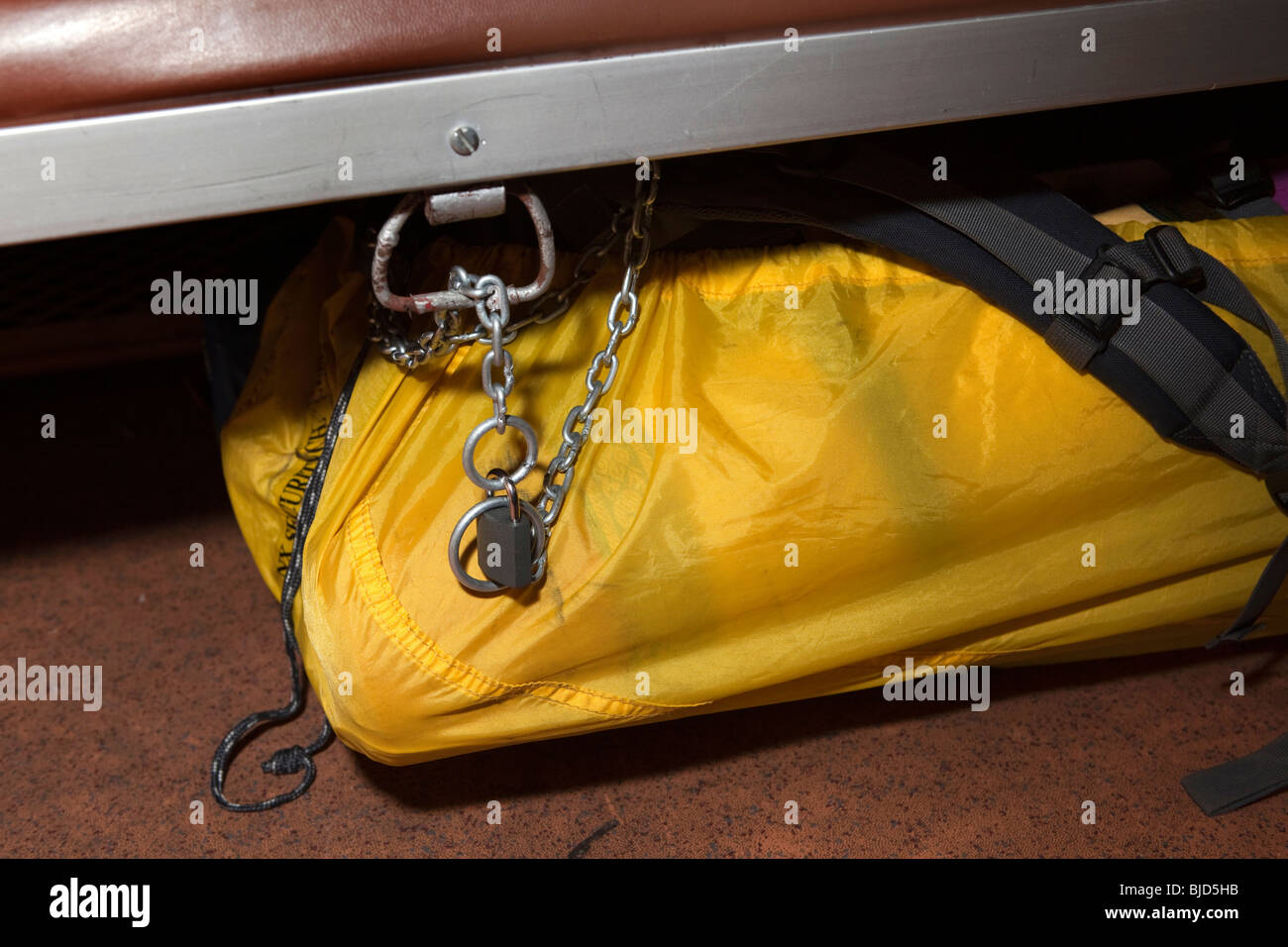 India, Kerala, Kochi, rail travel security, western travellers bag secured with chain and lock under railway seat Stock Photo