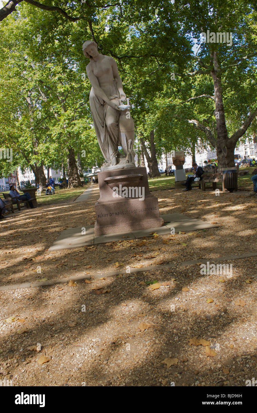 statue, trees and seating in Hanover square, london, uk Stock Photo