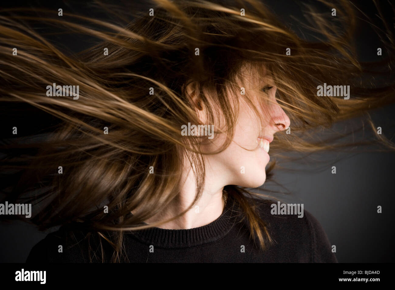 Woman flipping hair Stock Photo - Alamy