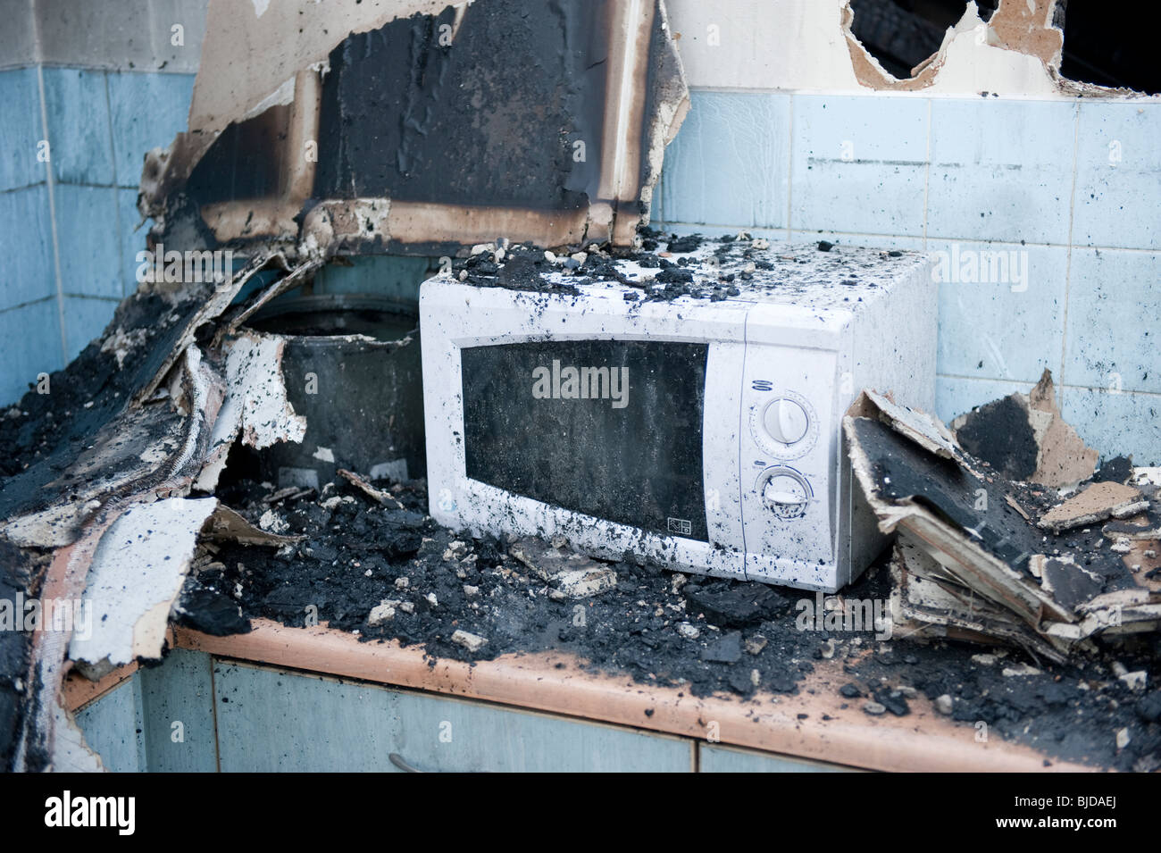 Melted microwave oven following kitchen fire Stock Photo