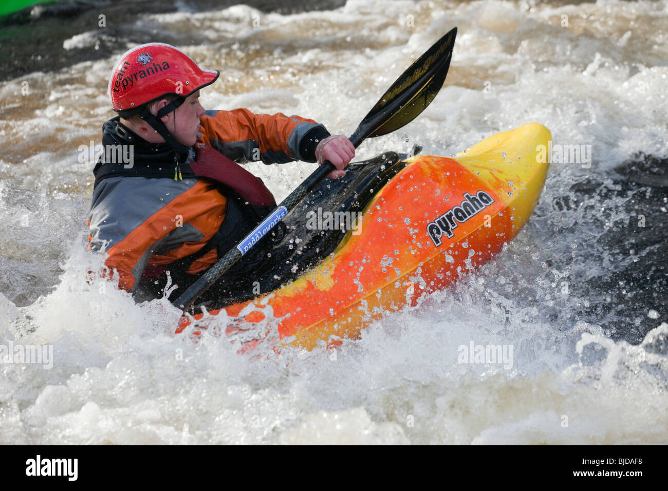Kayaker kayaking in white water on Tryweryn River. National Whitewater Centre, Frongoch, Gwynedd, North Wales, UK. Stock Photo