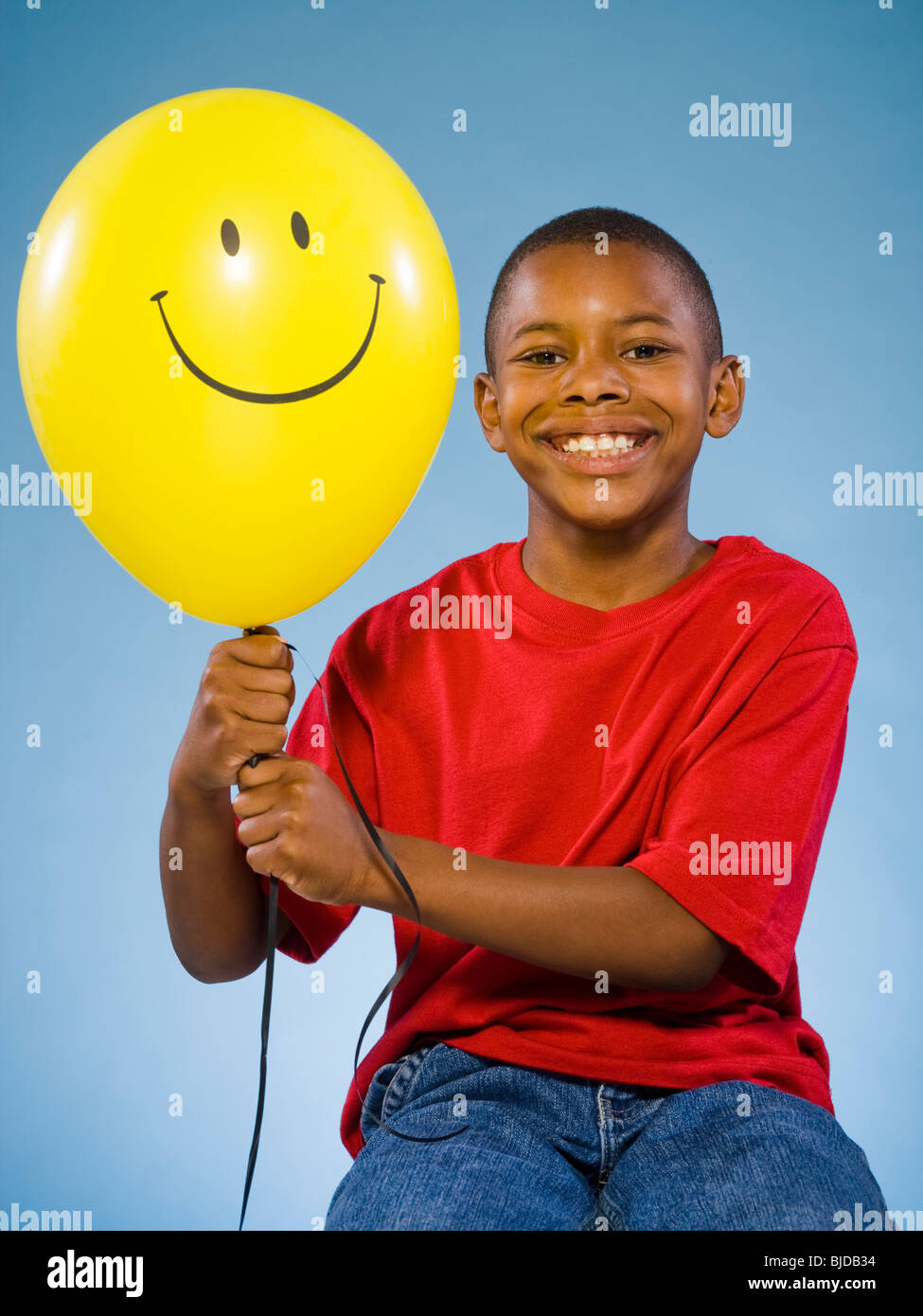 Child holding a balloon Stock Photo - Alamy