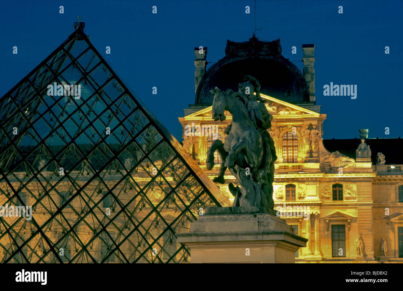 Paris, France, - I.M. Pei Pyramid at the Louvre Museum, with Statue of King Louis XIV (Artist: Bernin), Night View.Cour Napoleon Stock Photo