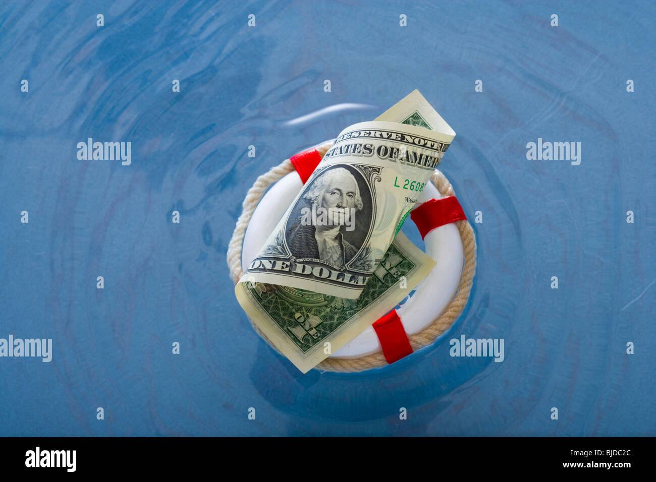 Money in a life saver. Stock Photo