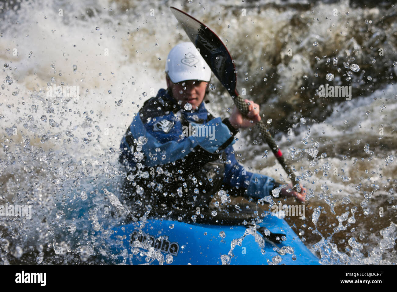 Kayaker kayaking in white water on Tryweryn River at National Whitewater Centre, Frongoch, Gwynedd, North Wales, UK, Britain. Stock Photo