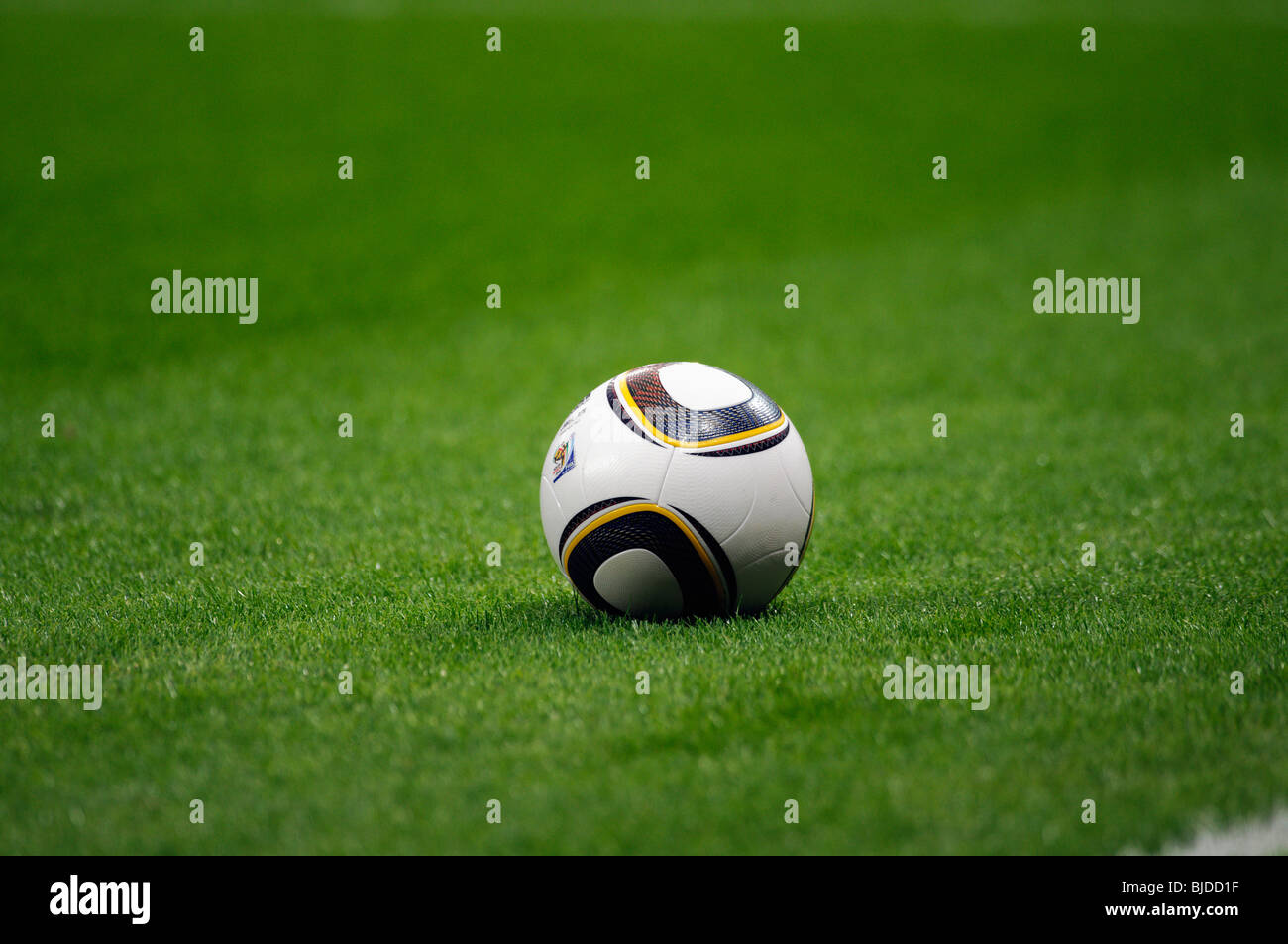 Jabulani, official matchball of th FIFA Football World Cup 2010 in South Africa on  green pitch Stock Photo