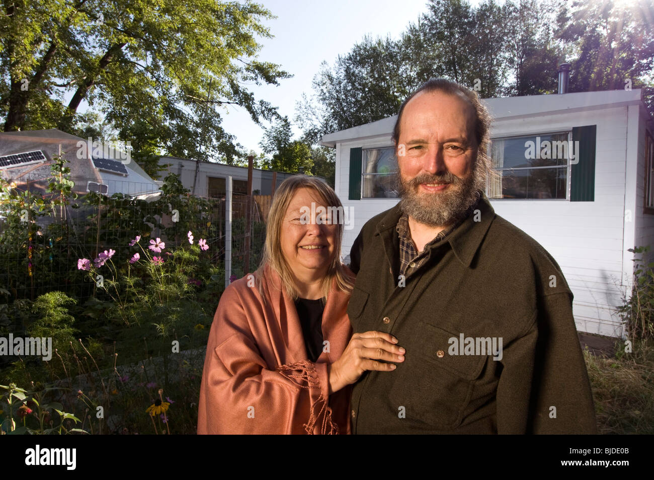 a middle-aged couple stand in front of their mobile home Stock Photo ...