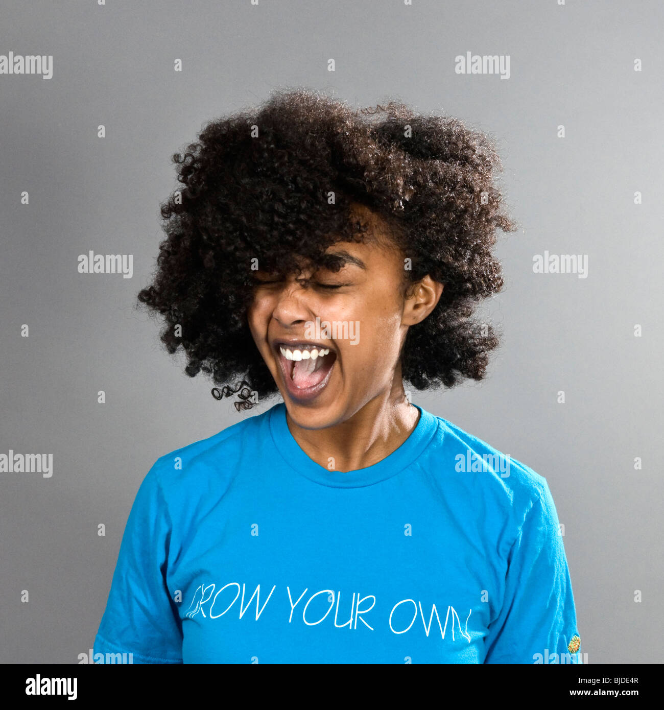 With loud laughs, she throws her hair around Stock Photo - Alamy