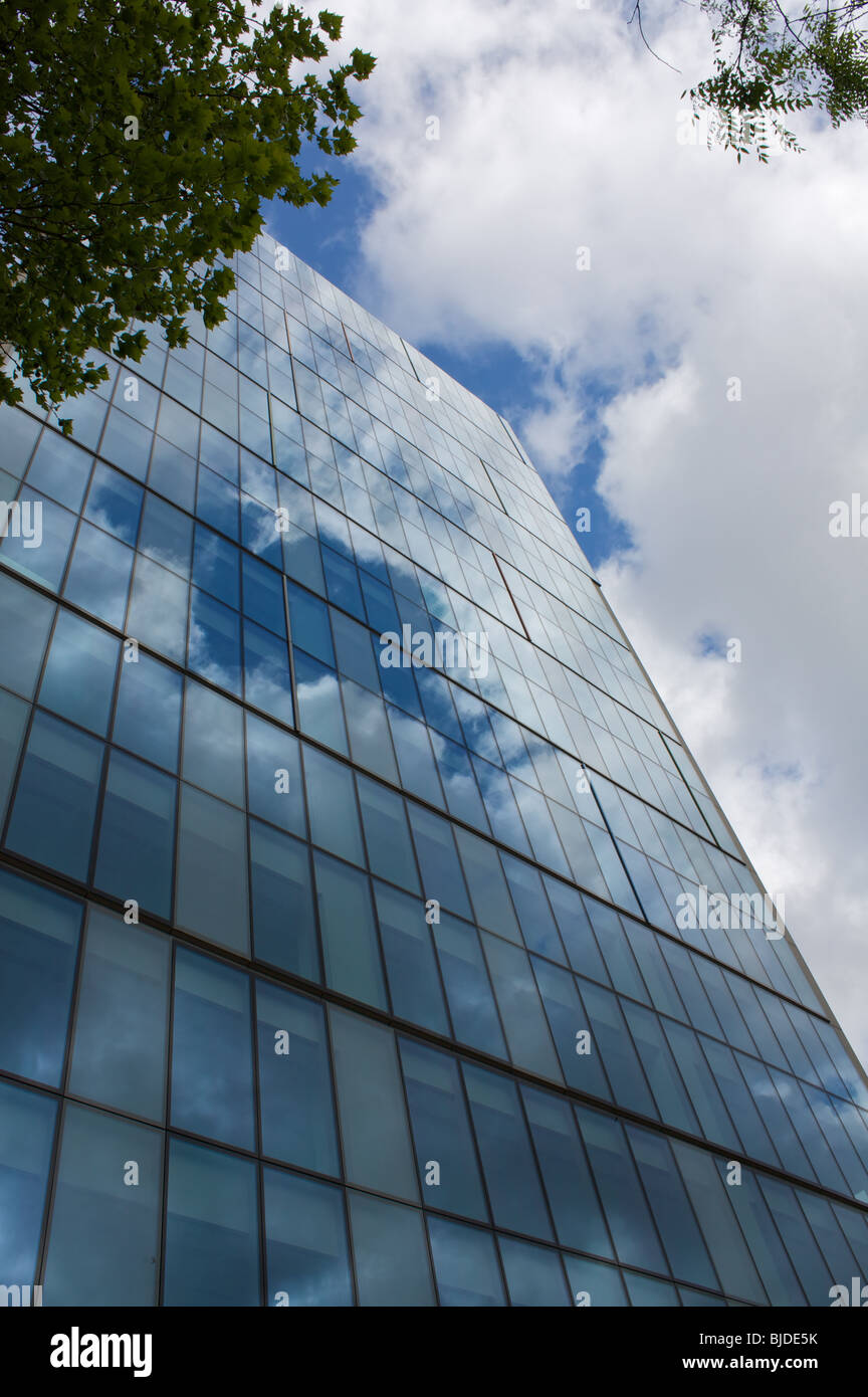 Vertical view of a Glass building in the city of london reflecting blue ...