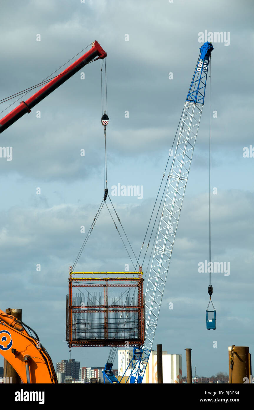 Crane jibs at a construction site at Salford Quays, Manchester,  UK Stock Photo