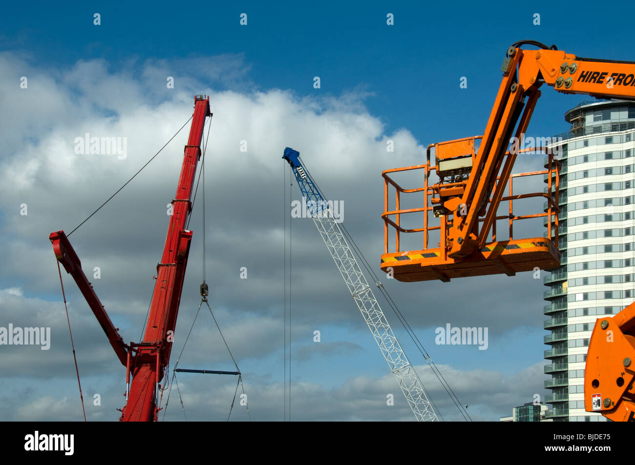 Access platform with The Heart apartment block and cranes in the background, Salford Quays, Manchester, UK Stock Photo