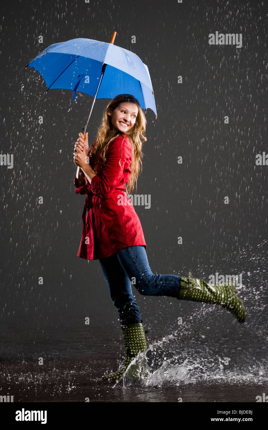young woman holding an umbrella Stock Photo - Alamy