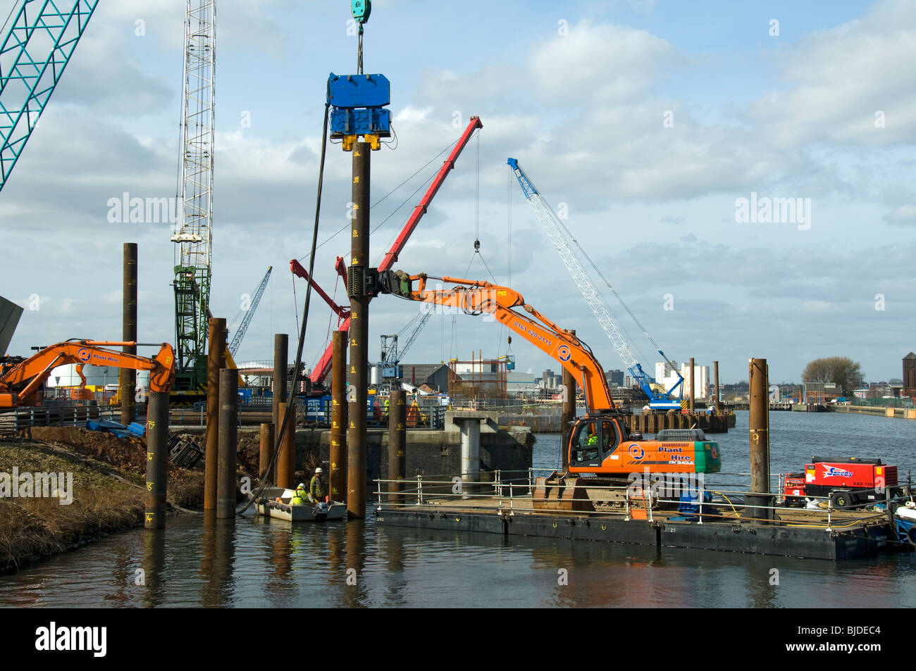 Pile driving operation, using a vibratory pile driver, outside the Imperial War Museum North at Salford Quays, Manchester, UK Stock Photo