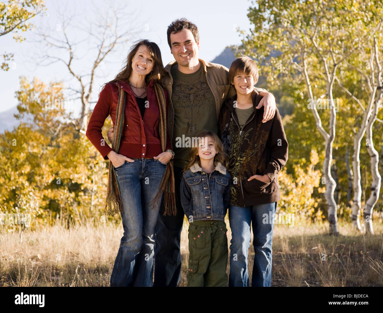 Family of four, outdoors. Stock Photo
