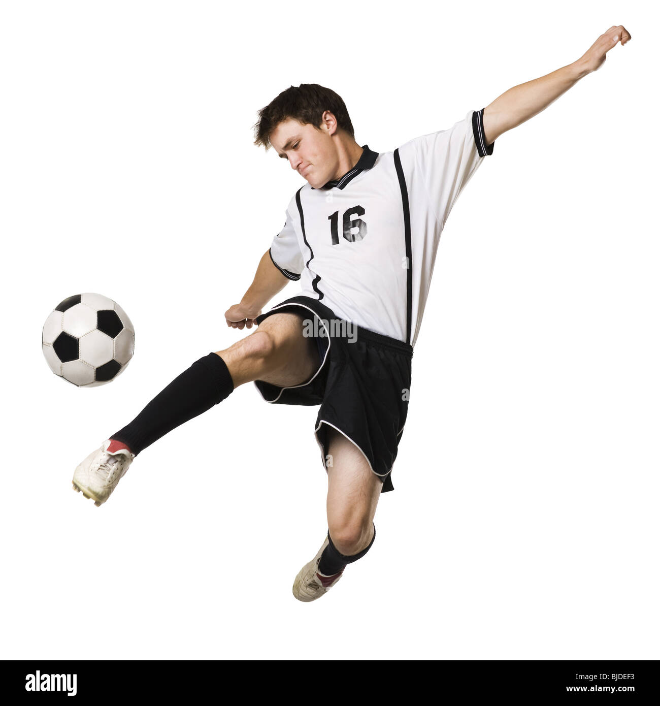 Young man kicking a soccer ball. Stock Photo