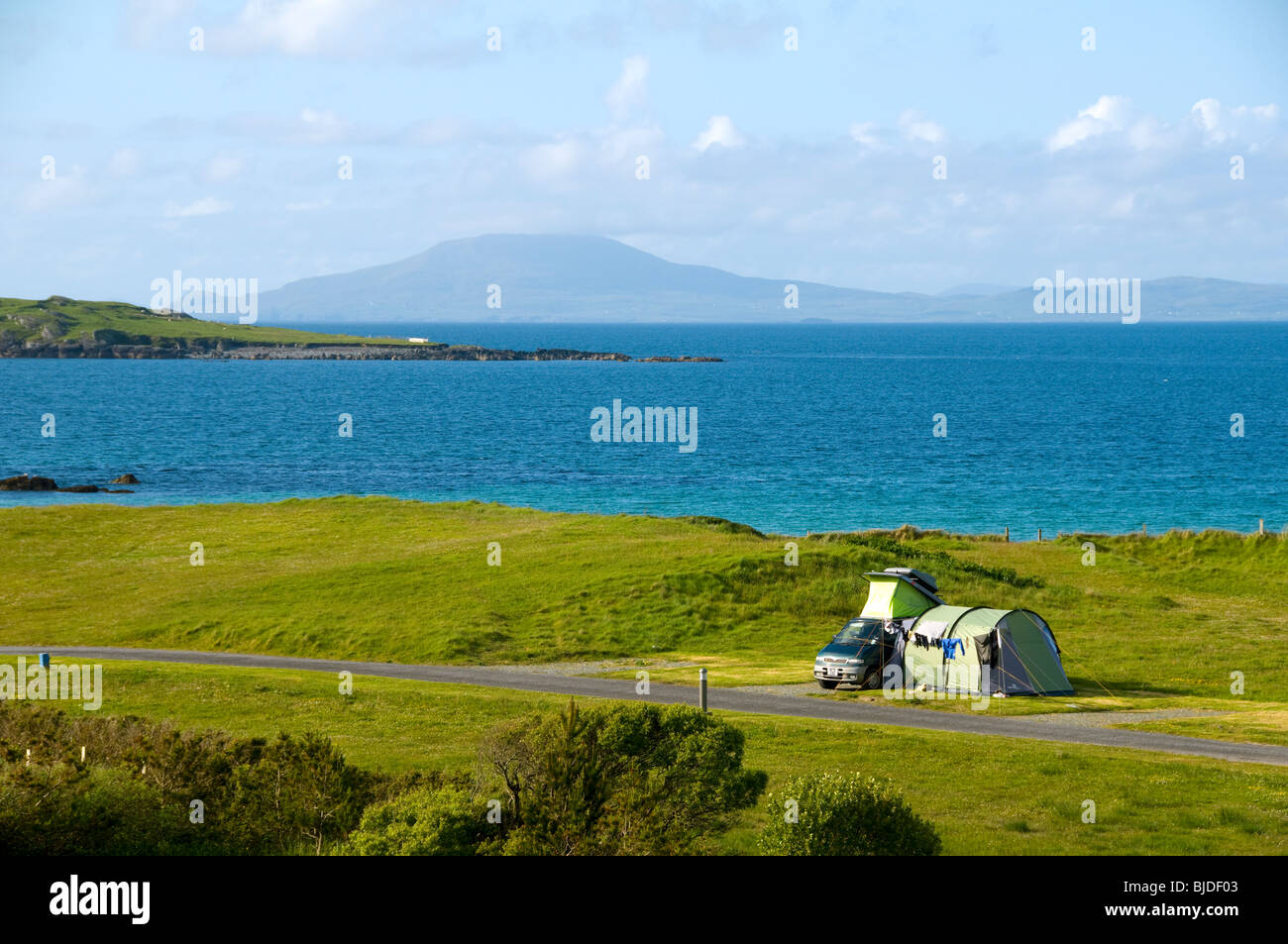 Small campervan with side awning on a camp site at Renvyle Beach, Connemara, County Galway, Ireland Stock Photo
