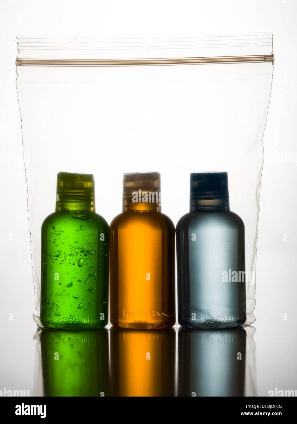 three different Colored bottles in a plastic bag. Stock Photo