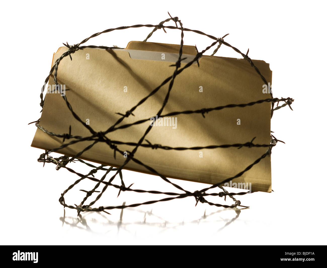 Manila file folder surrounded by barbed wire. Stock Photo