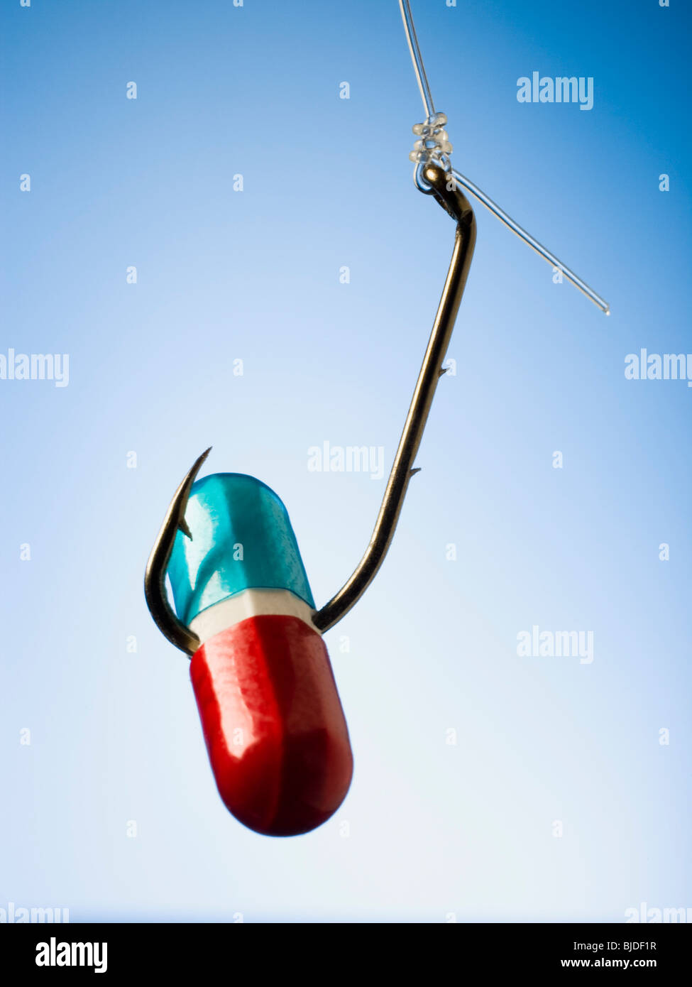 Pill on a fish hook. Stock Photo