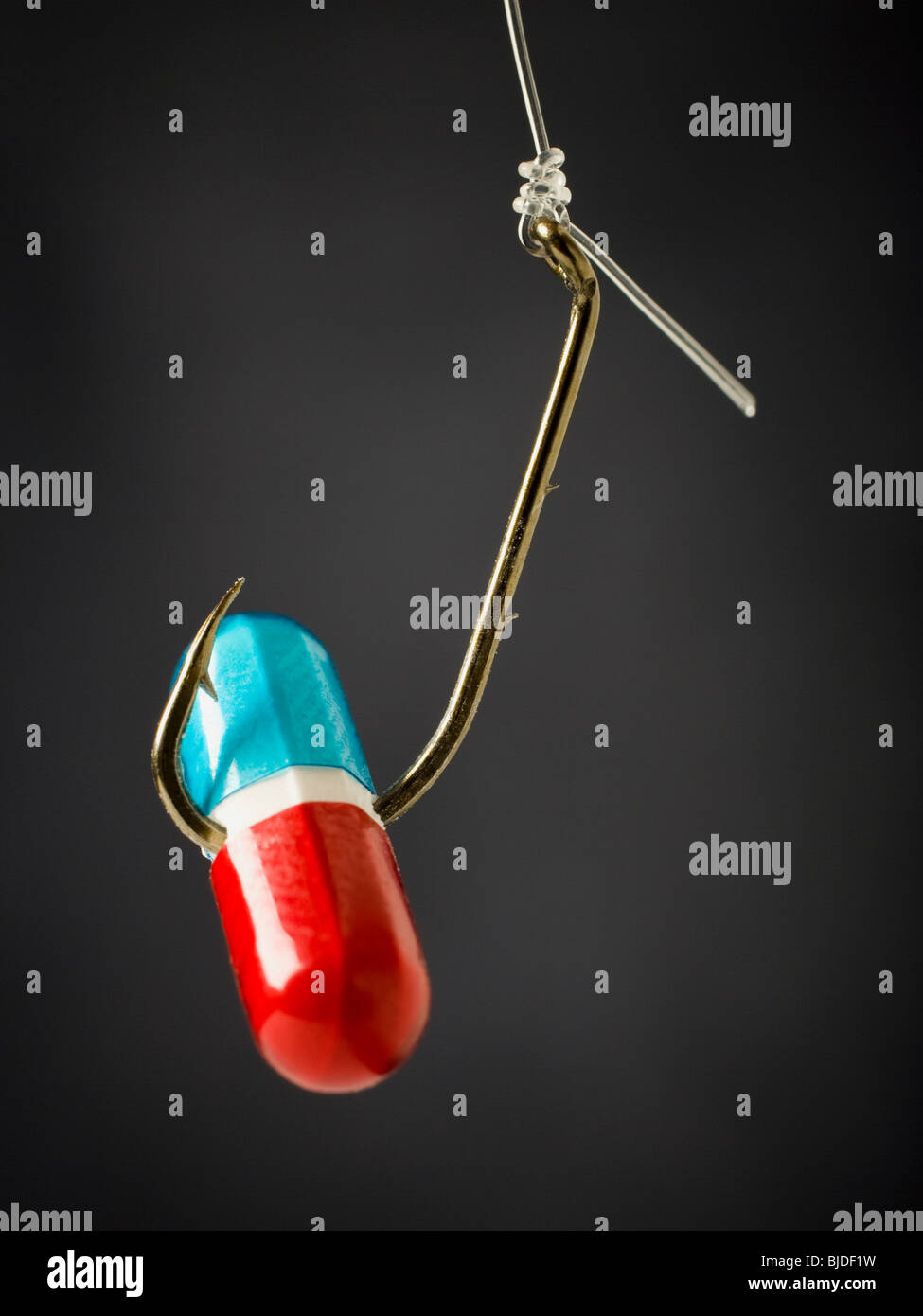 Pill on a fish hook Stock Photo Alamy