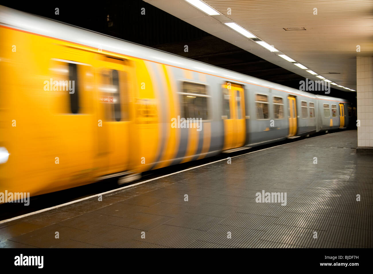 Merseyrail train leaving platform Stock Photo