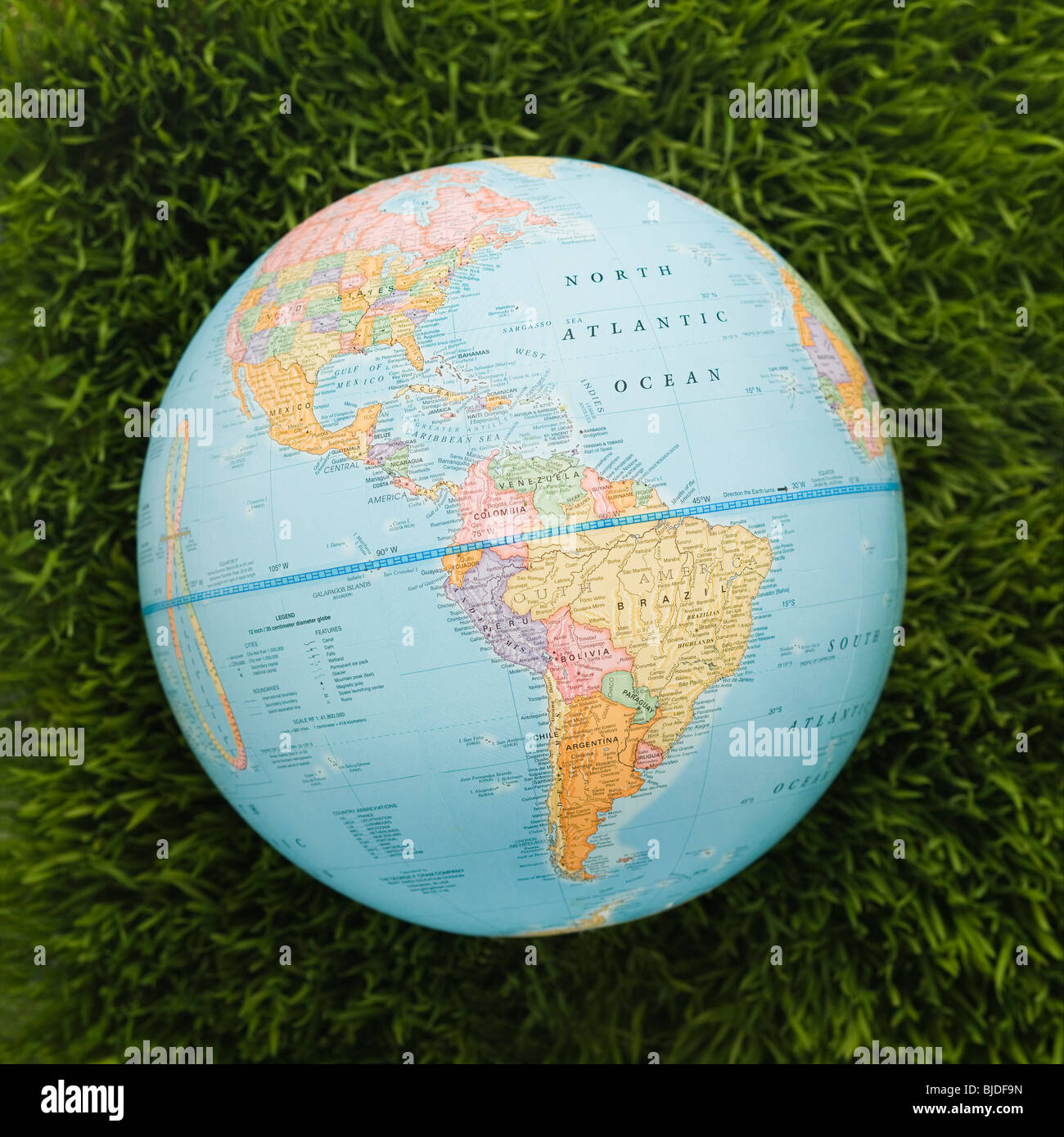 Globe against background of grass. Stock Photo