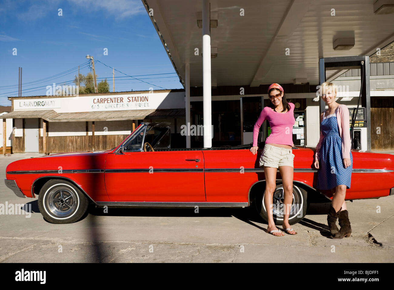 two women at a gas station. Stock Photo