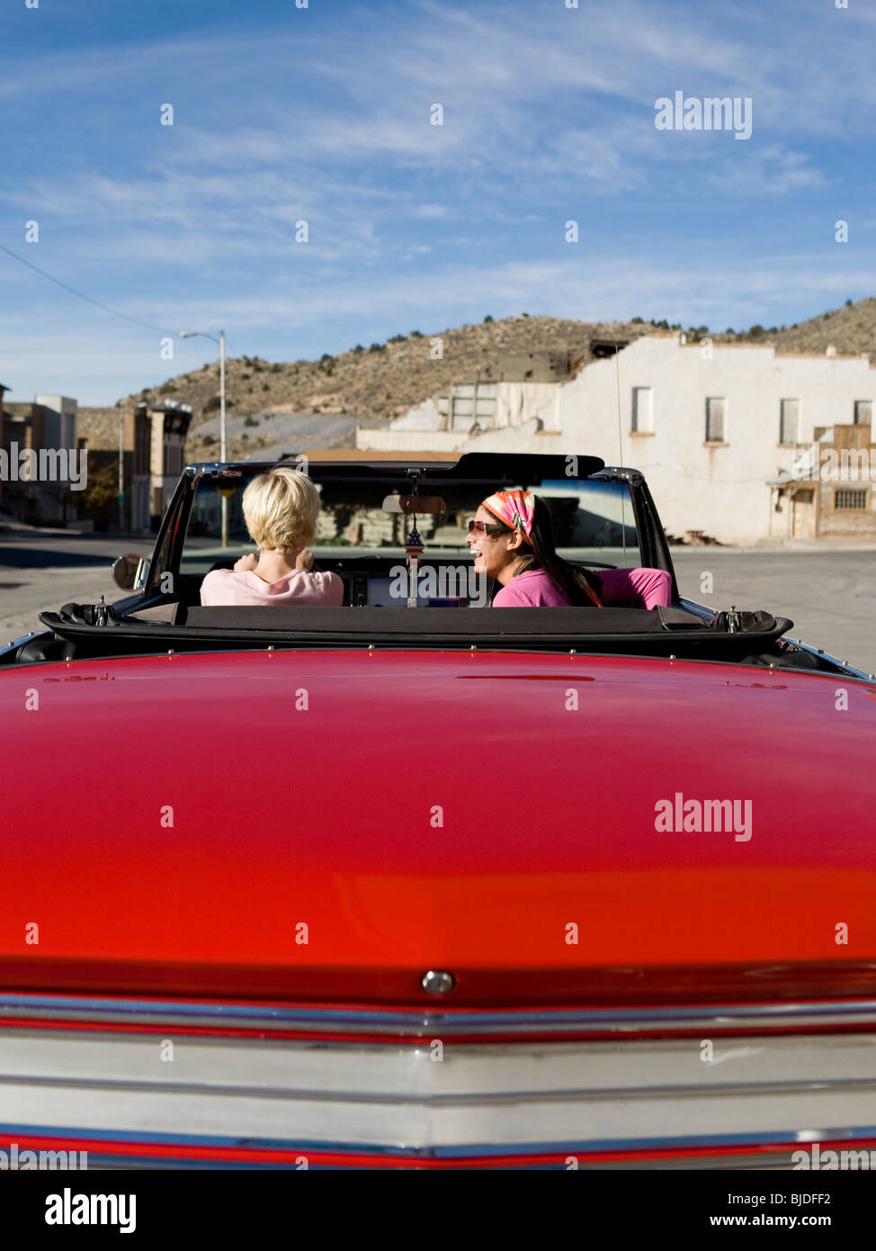 two women in a red convertible. Stock Photo