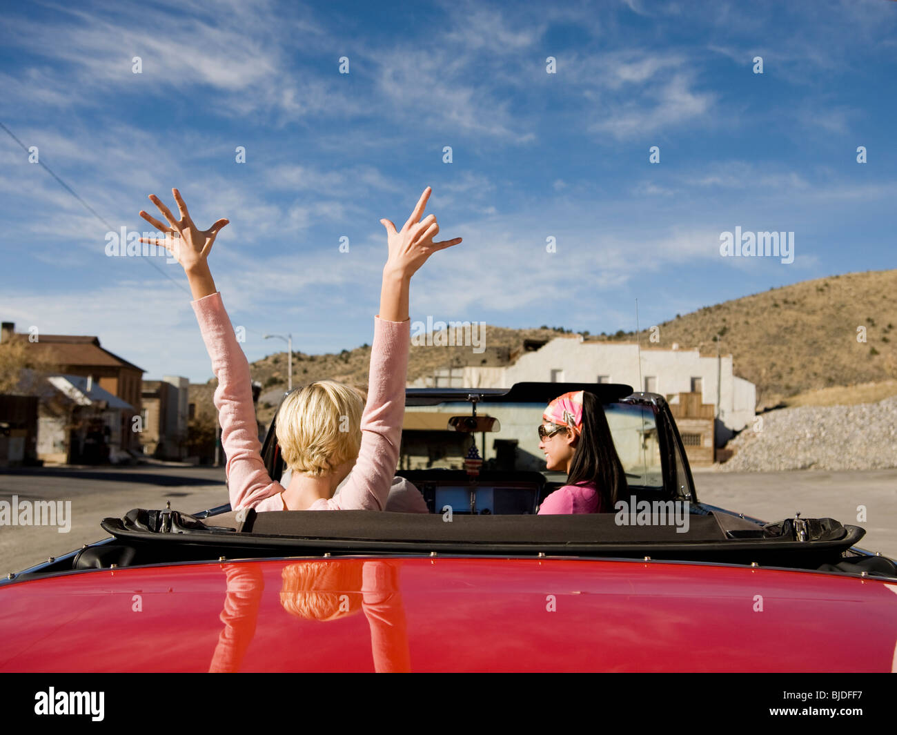 two women in a red convertible. Stock Photo