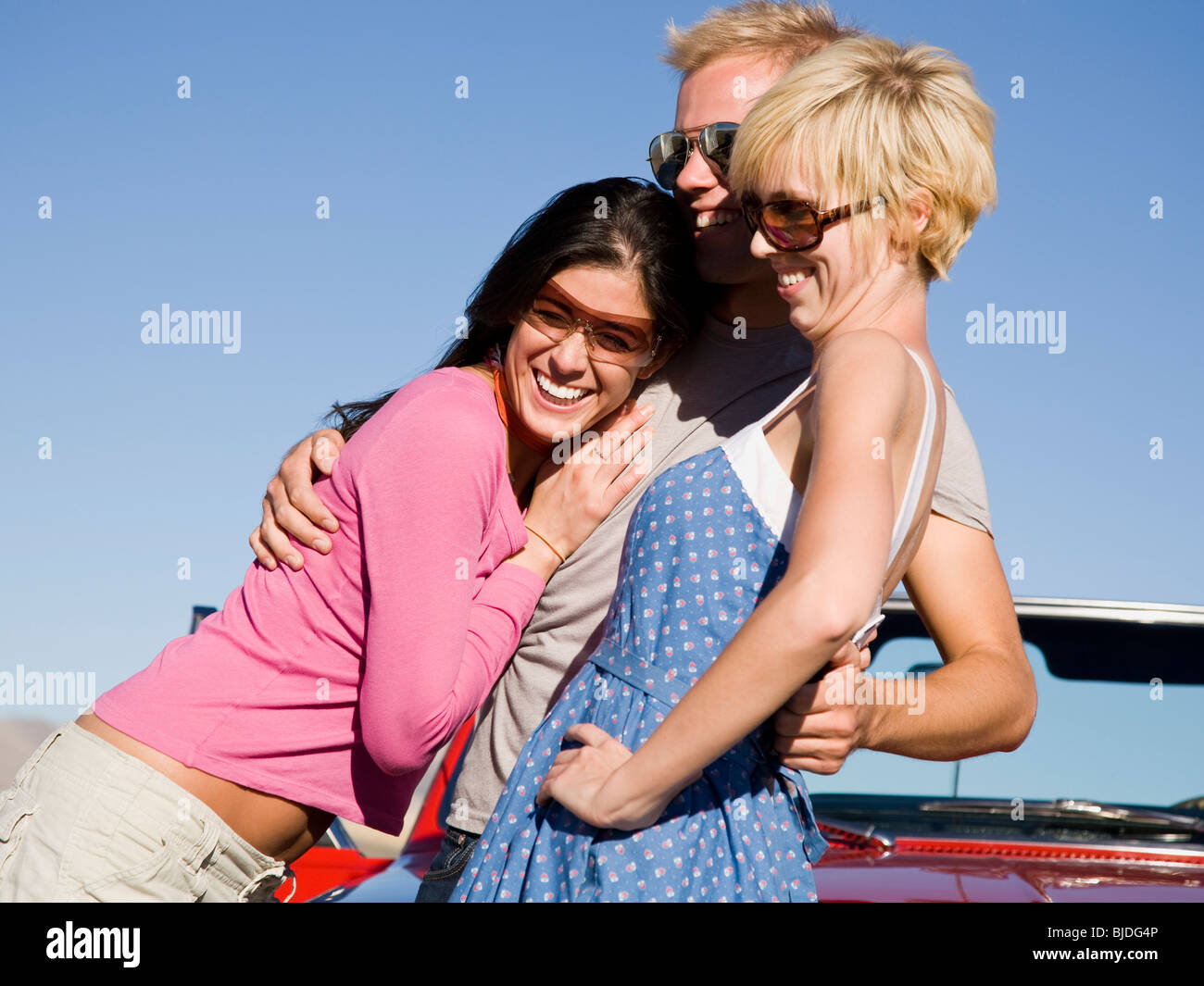 man and two women. Stock Photo
