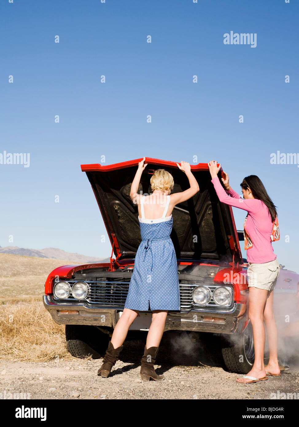 two women with car trouble. Stock Photo