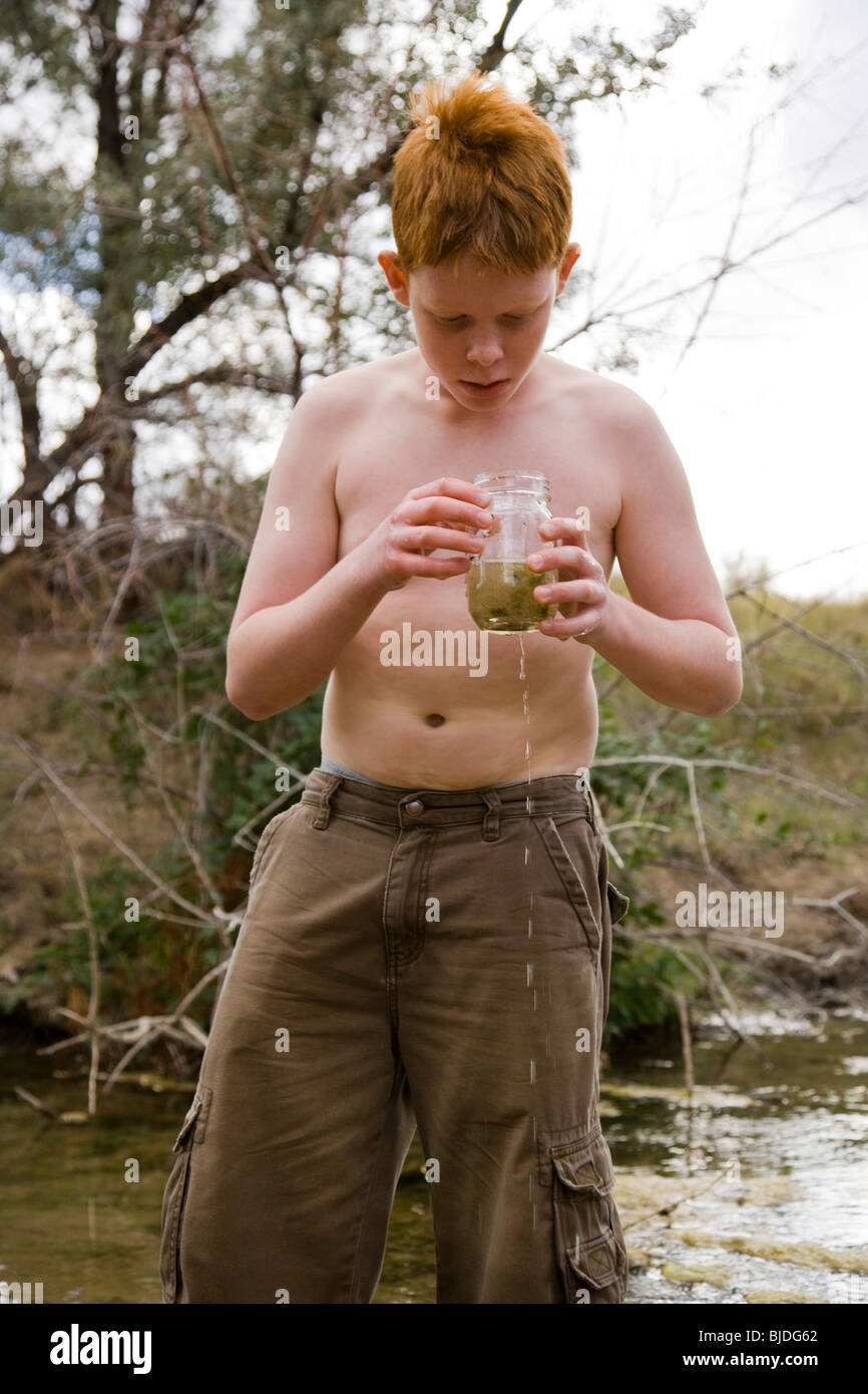boy playing in a river. Stock Photo