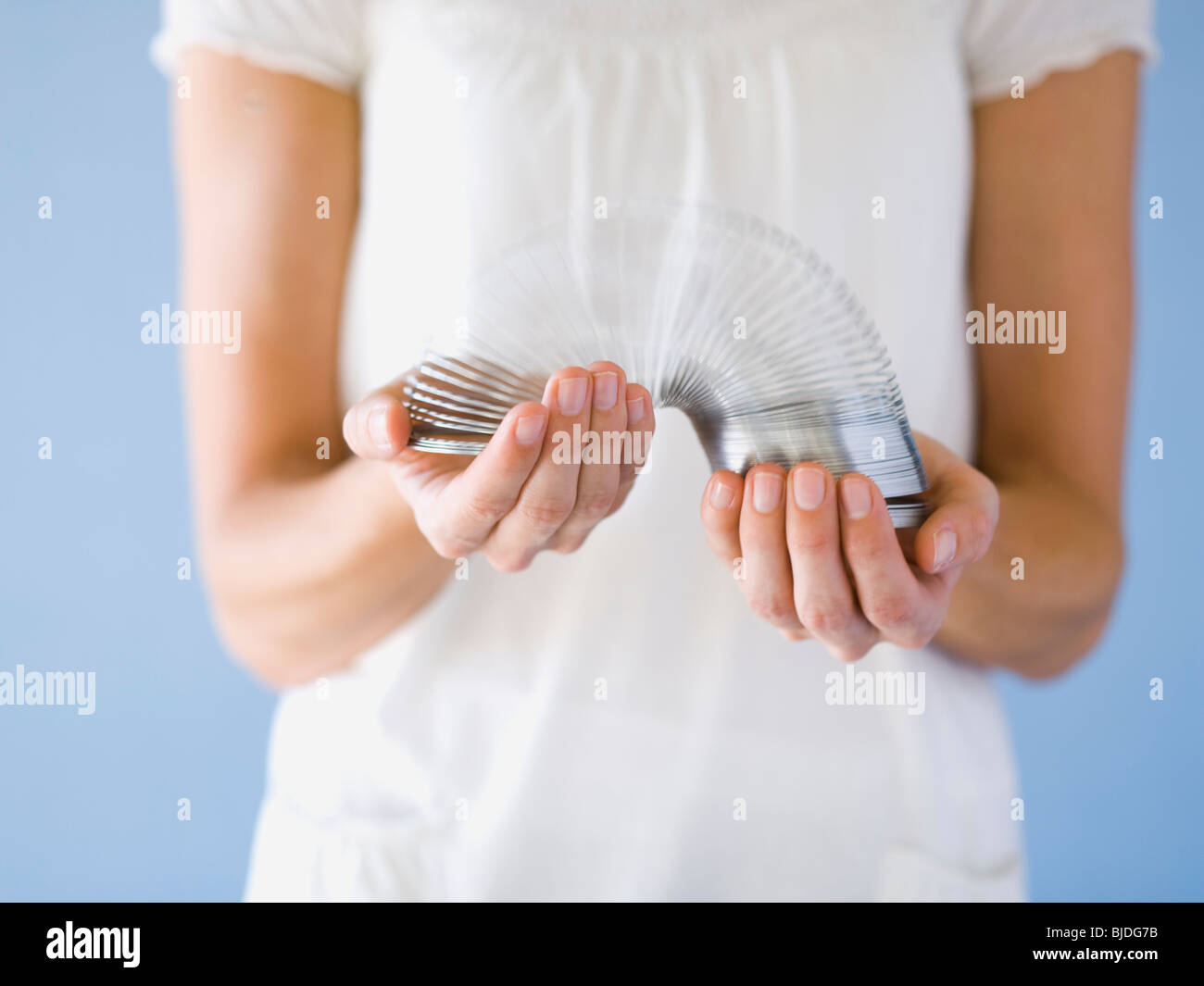woman holding a slinky. Stock Photo