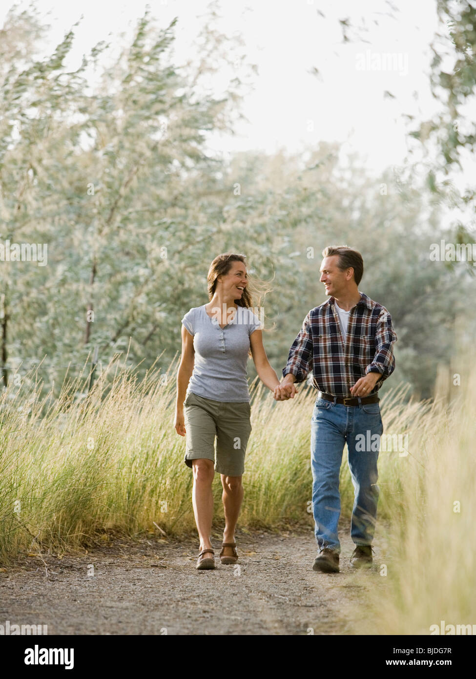 man and woman holding hands and walking. Stock Photo
