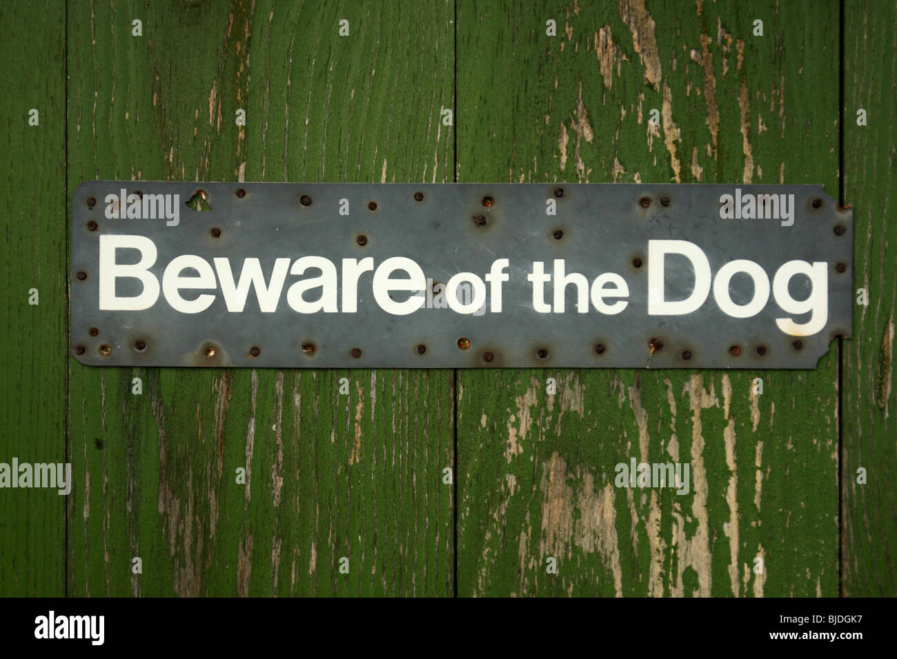 'Beware of the Dog' Sign on a wooden gate Stock Photo