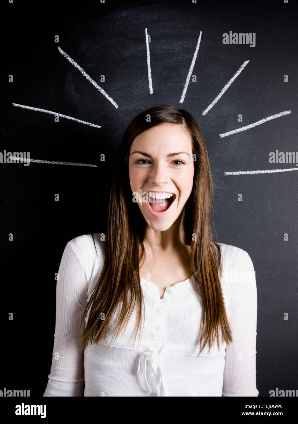 young woman against a chalkboard Stock Photo