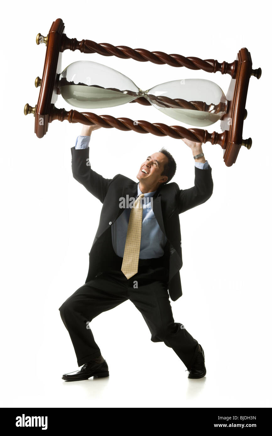 businessperson holding up an hourglass Stock Photo