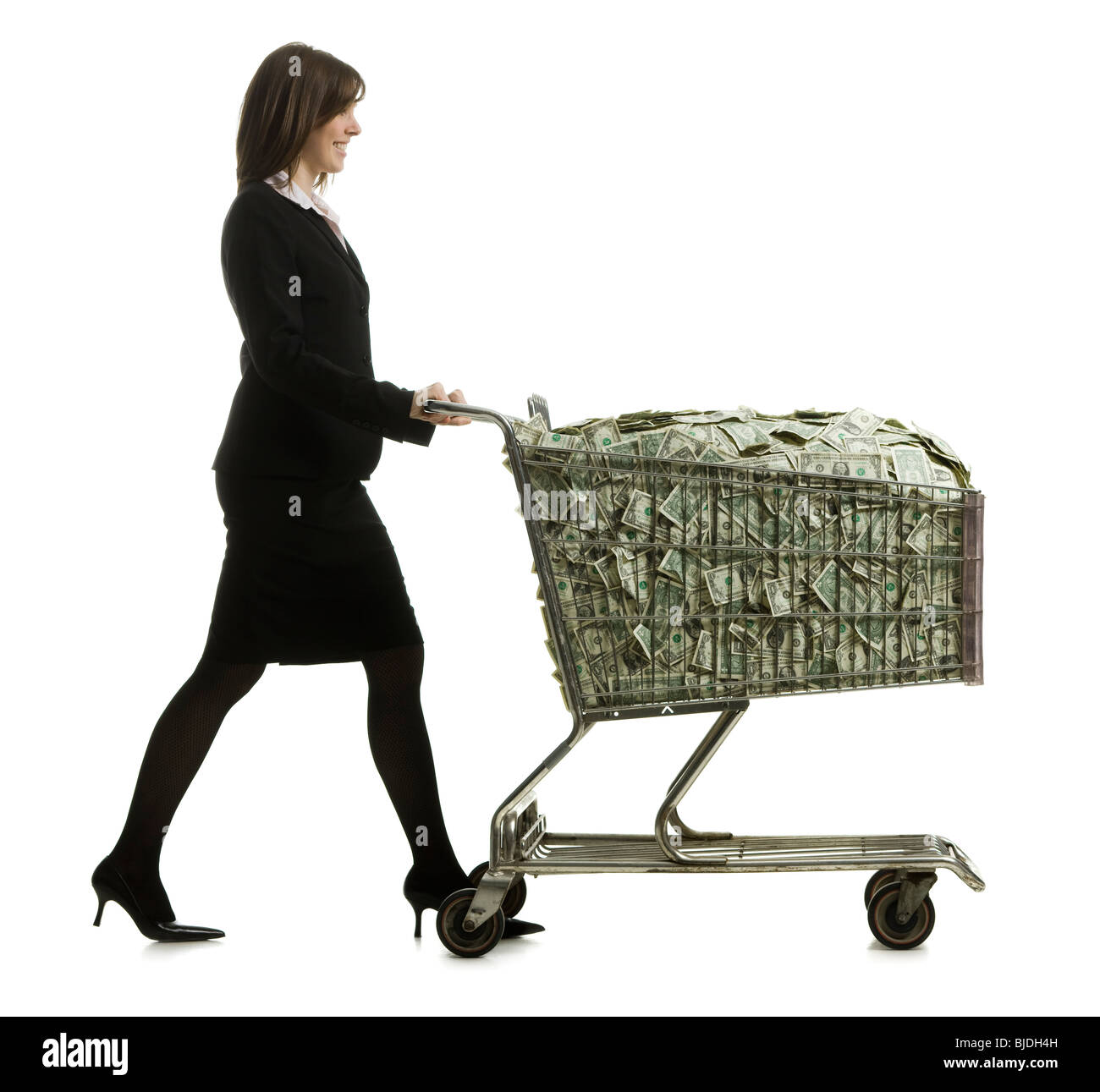 businessperson with a shopping cart full of money Stock Photo