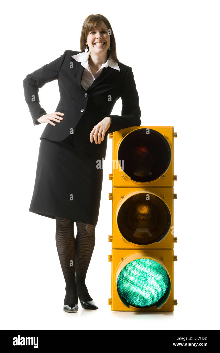 businessperson holding a traffic signal Stock Photo