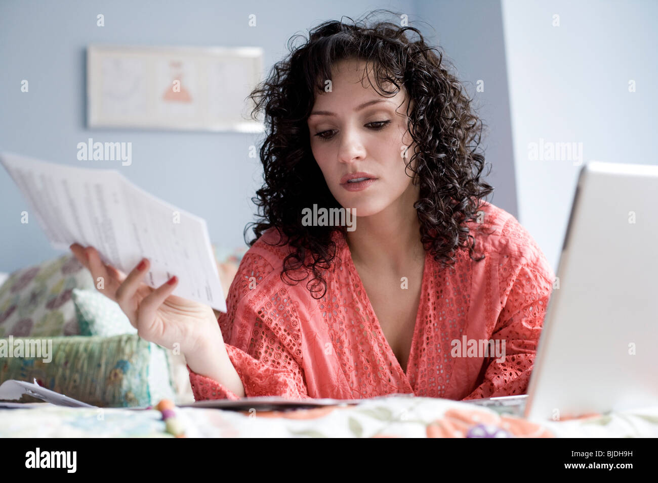 woman lying on a bed with a notebook computer Stock Photo - Alamy
