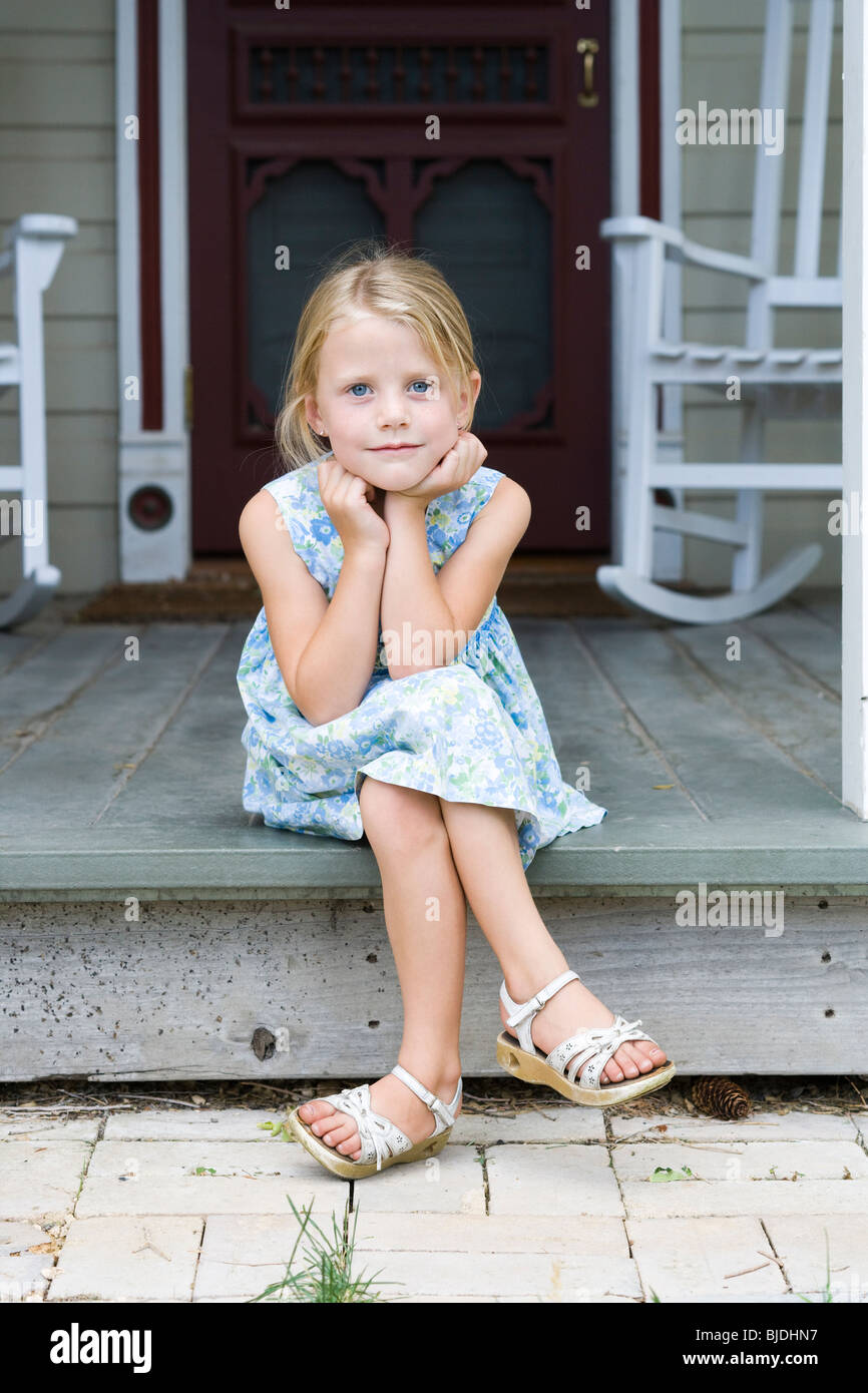 girl sitting on the front porch Stock Photo Alamy
