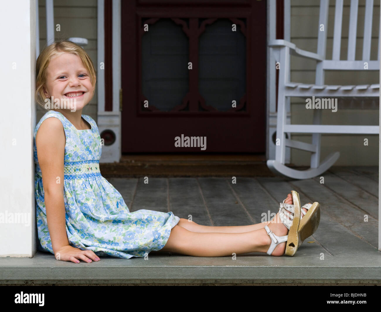 girl sitting on the front porch Stock Photo Alamy