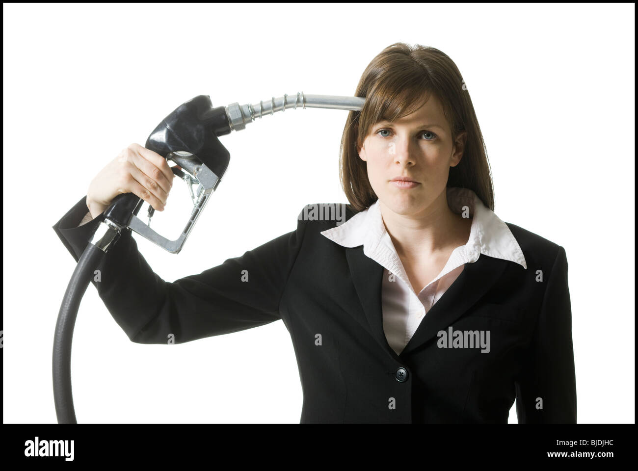 woman holding a gas pump to her head Stock Photo