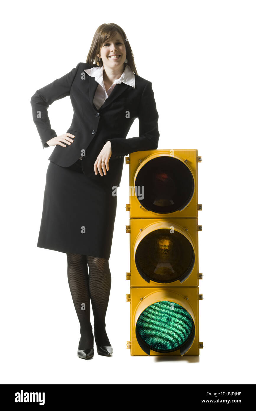 businessperson holding a traffic signal Stock Photo