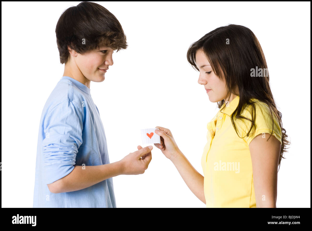young couple passing a note Stock Photo